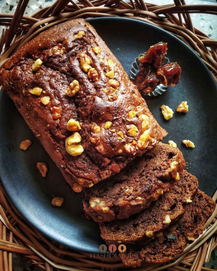 a loaf of chocolate bread with nuts on top