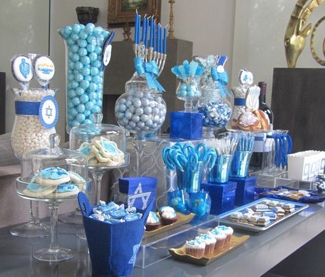 an assortment of desserts and candies displayed on a table