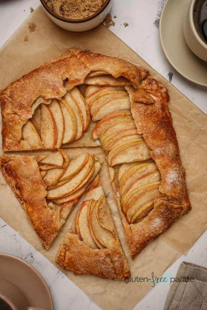 an apple pie is cut into slices on a cutting board