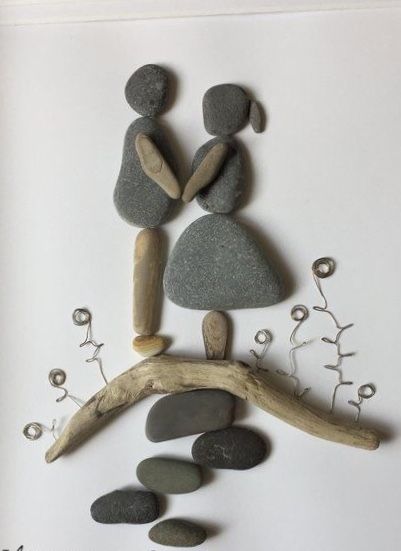 some rocks are arranged on top of a branch