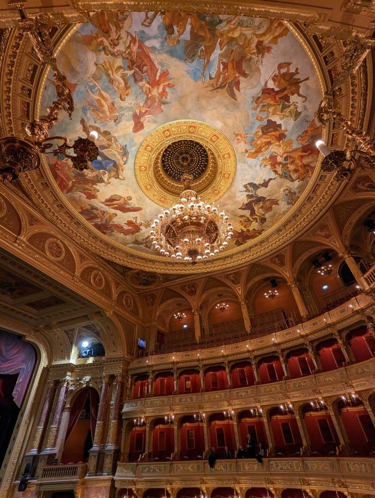 an ornately decorated auditorium with painted ceiling