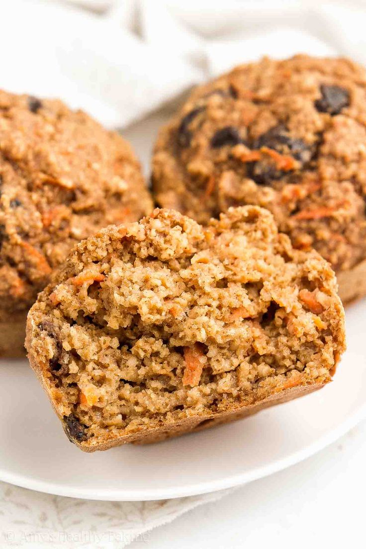 three carrot muffins on a white plate