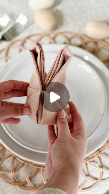 a person holding a napkin on top of a plate