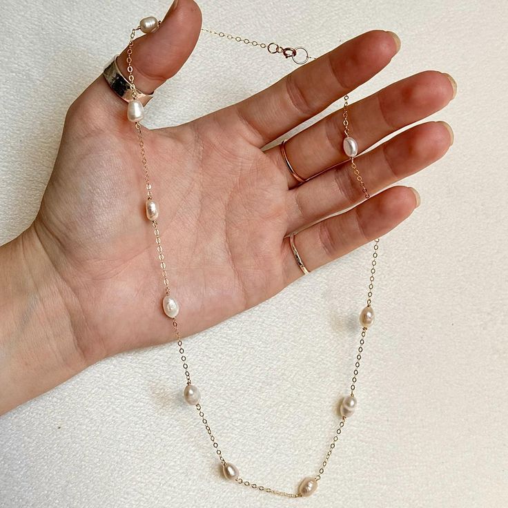 This dainty pearl necklace is made with real fresh water pearls on either a 14k gold filled chain or a sterling silver chain. The necklace includes 11 individually picked fresh water pearls. Due to all jewellery being handmade, no two pieces are exactly alike, making them more unique! Please feel free to message with any enquiries before placing your order. Dainty Single Strand Pearl Necklace In Sterling Silver, Silver 14k Gold-filled Necklaces With Pearl Charm, Silver 14k Gold-filled Necklace With Pearl Charm, Silver 14k Gold Filled Necklace With Pearl Charm, Silver Necklace With Pearl Charm In 14k Gold Filled, Silver And Pearl Necklace, Dainty Pearl Necklace, Bridesmaid Necklace Gift, Dainty Chain