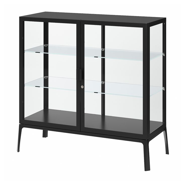 a black and white display case with glass doors on the bottom, two shelves below