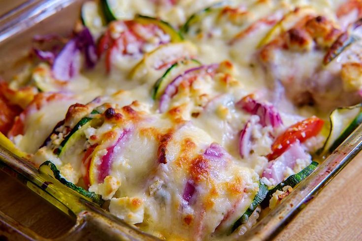 a casserole dish filled with vegetables and cheese