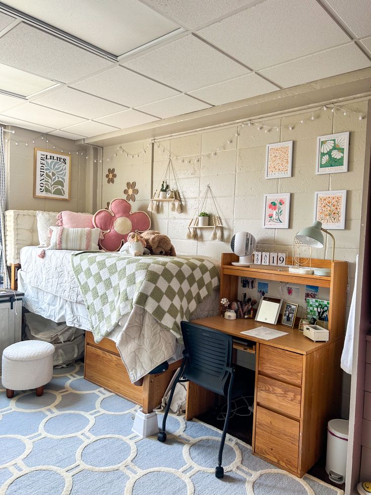 a bed room with a neatly made bed and desk