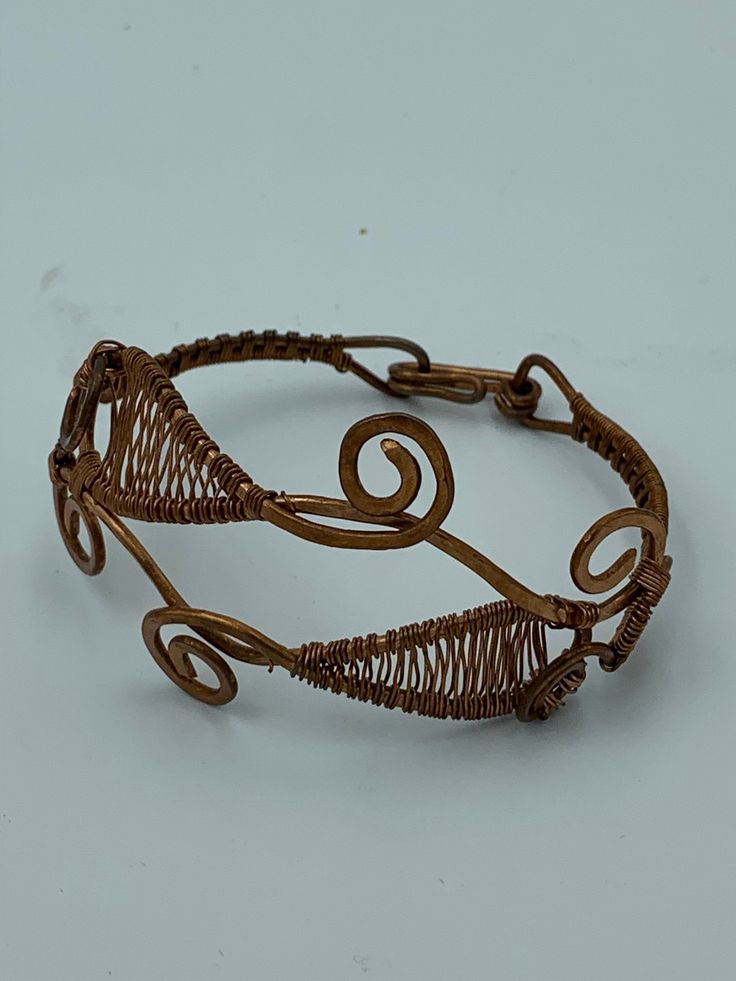 An elaborately wire wrapped copper bracelet. About 6 inches around. Adjustable Copper Wire Bangle Bracelet, Adjustable Copper Wire Bangle, Handmade Copper Wire Bangle Bracelet, Copper Wire Wrapped Bangle Bracelet, Bohemian Copper Wire Cuff Bangle Bracelet, Bohemian Bangle Bracelet In Copper Wire, Bohemian Copper Wire Bangle Bracelet, Copper Wire Wrapped Bangle, Unique Copper Wire Wrapped Cuff Bracelet