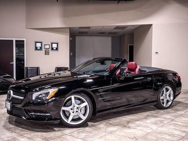 a black car is parked in a showroom