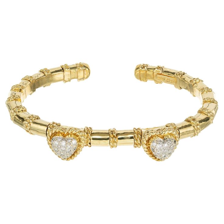 Cassis diamond dangle heart bracelet. 34 round full cut diamonds set in double twisted gold wire heart shapes, set along an 18k yellow gold slip on bracelet with twisted gold wire separators. Fits a 7-7.5 inch wrist. 34 round full cut diamonds, G VS-SI approx. .55cts 18k yellow gold Stamped: 18k Hallmark: Cassis 30 grams Shape: Oval Heart Bangle Bracelet, Wire Heart, Gold Wire, Heart Bracelet, Gold Heart, Heart Of Gold, Bangle Bracelet, Hallmark, Bangle Bracelets