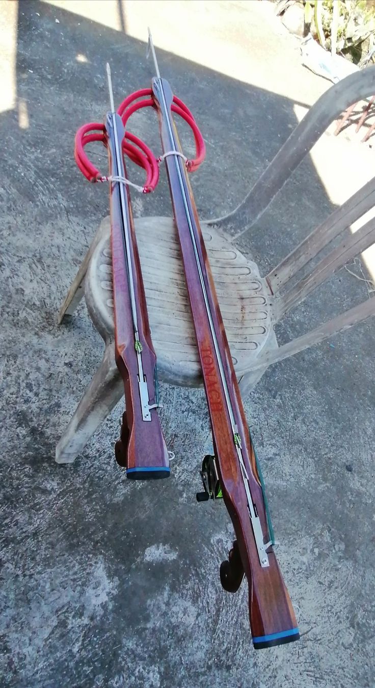 two wooden skis sitting next to each other on the ground