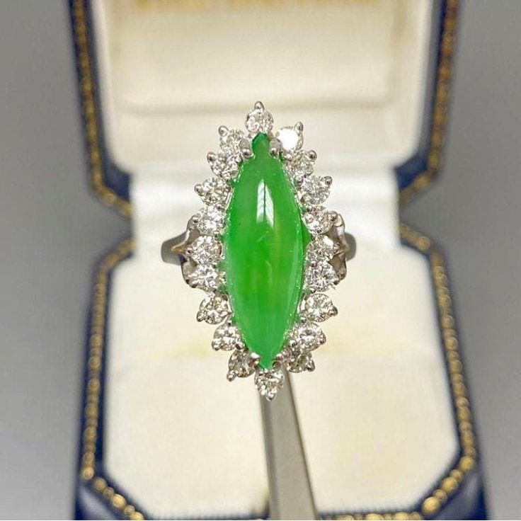 "Pacific Jewelry Presents, 20 Scintillating VS clarity diamonds centering a high quality Marquise shaped Jade. This ring centers a 3 carat Jade Gemstone with oriental origins. As the Chinese saying goes, \"Gold is valuable, but Jade is priceless\", no gemstone in history holds the metaphysical and religious significance as Jade, particularly in Chinese and Mayan/Aztec cultures. ✔ Gold Karat: 14K White Gold ✔ Jade Weight: Approximately 3 carats ✔ Jade Origin: Burma ✔ 3rd party Certificatory/Appra Formal Turquoise Diamond Ring With Gemstone, Formal Turquoise Diamond Ring, Fine Jewelry Chrysoprase For Formal Occasions, Green Oval Turquoise Wedding Ring, Formal Fine Jewelry Turquoise Diamond Ring, Green Turquoise Oval Ring For Wedding, Fine Jewelry Chrysoprase Rings For Anniversary, Fine Chrysoprase Rings For Anniversary, Anniversary Chrysoprase Rings Fine Jewelry