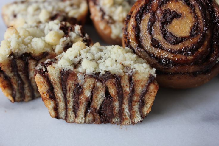 some type of pastry sitting on top of a white countertop next to other pastries