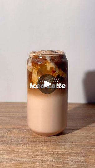 a glass jar filled with liquid sitting on top of a wooden table