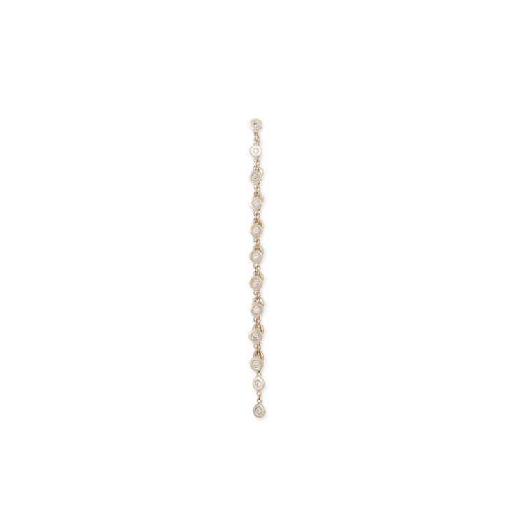 a single strand of pearls hangs from a chain