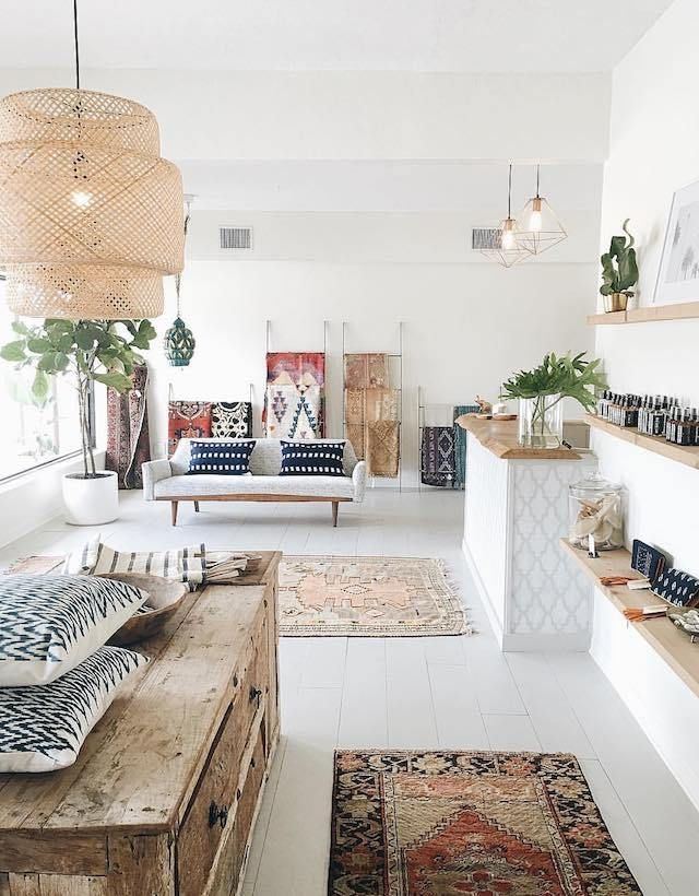 a living room filled with lots of furniture and rugs on top of it's floors