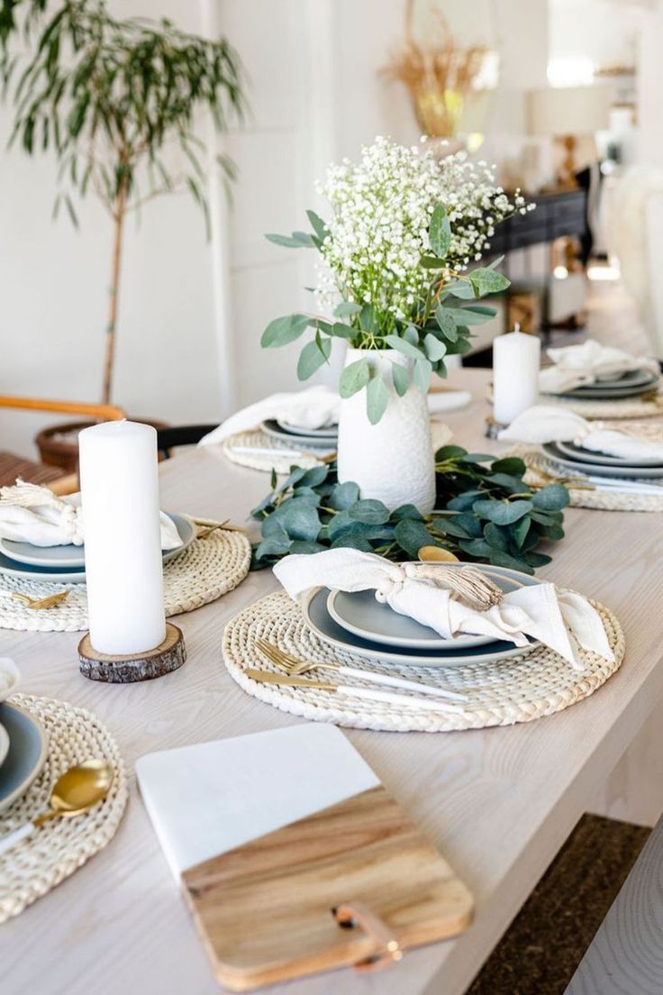 the table is set with plates and place settings