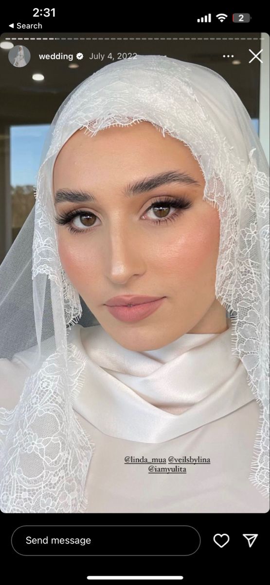 a woman wearing a veil and white dress