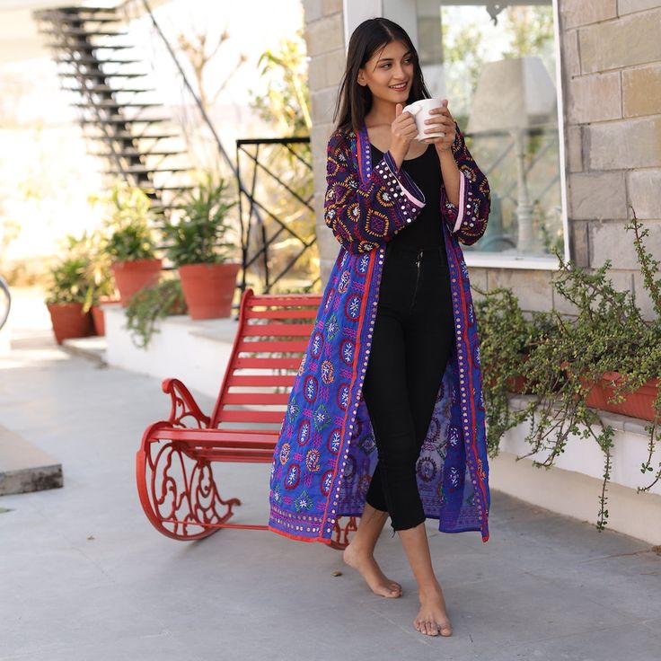 These colorful phulkari kimonos are hand embroidered and embellished. They are so cute with jeans, over swimsuits, shorts, or as robes. Each is one of a kind. Phulkari is a type of fabric that originated in Punjab. It is characterized by floral and geometric designs embroidered with silk thread using a long darning stitch on hand-dyed, semi-transparent fabric. They are embellished with silver and gold colored roundels along the edges. Long Floral Embroidered Kimono For Festival, Long Floral Embroidery Kimono For Festivals, Festival Embroidered Kimono, Bohemian Kimono With Chikankari Embroidery For Festivals, Traditional Embroidered Summer Kimono, Traditional Floral Embroidery Kimono For Beach, Traditional Multicolor Embroidered Summer Kimono, Summer Festive Embroidered Kimono, Embroidered Multicolor Kimono For Festivals