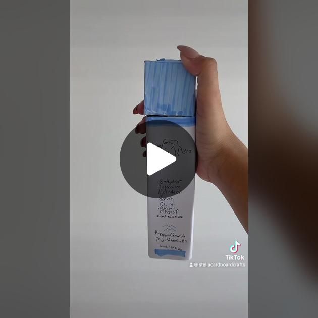 a person holding up a bottle of water with the caption's video below it