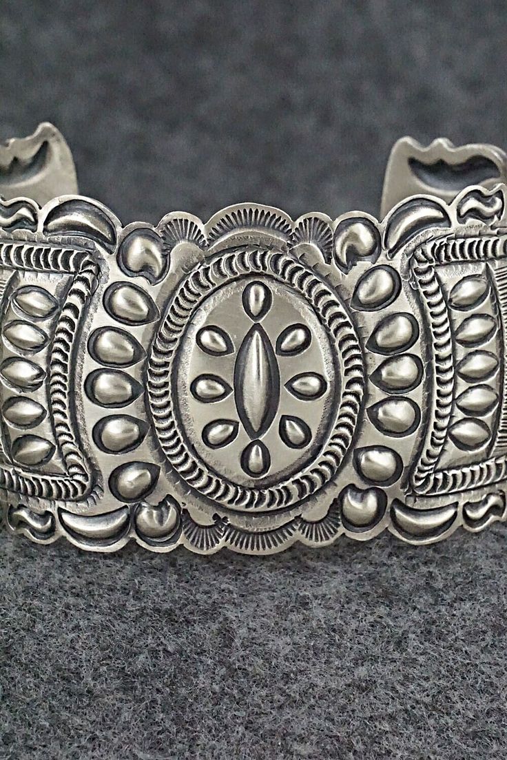 This stunning and intricate sterling silver bracelet was made by Navajo silversmith Eugene Charley. The inside is signed and stamped sterling.Size: 6" (will fit up to a 7 3/8" wrist)Gap: 1 3/8"Width: 1 1/2"Free shipping on all orders! We ship with USPS and always include tracking. All orders ship within a day of payment.Returns are accepted up to 30 days after you receive your order. Just send us a message. Our shop offers cash back or store credit. The item must be returned in new condition. Luxury Southwestern Sterling Silver Bracelet Gift, Antique Silver Sterling Silver Bracelet With Intricate Design, Antique Silver Sterling Silver Bracelets With Intricate Design, Artisan Sterling Silver Bracelet With Intricate Design, Artisan Sterling Silver Bracelet With Etched Details, Artisan Silver Bracelet With Stamped Details, Artisan Engraved Sterling Silver Bracelet, Ornate 925 Stamped Bracelet Jewelry, Ornate 925 Sterling Silver Bracelet