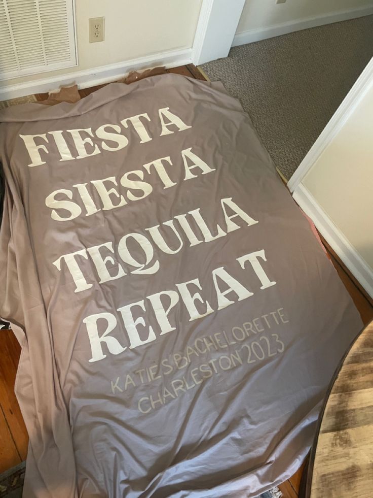 there is a sheet that says fiesta siestta tequila repat on the floor