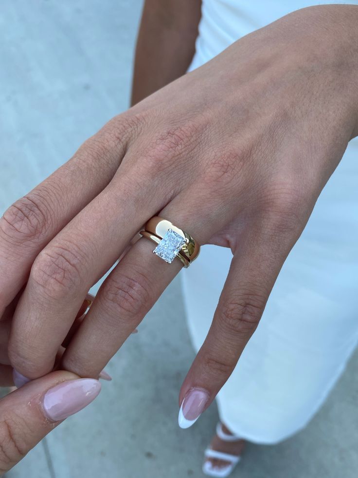 a close up of a person's hand with a ring on it