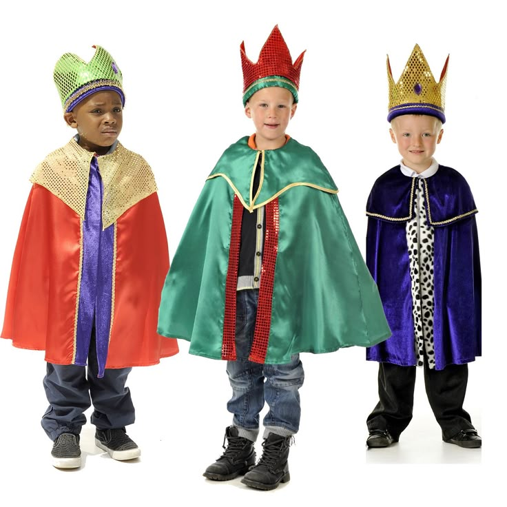 three children dressed up in costumes and hats, standing side by side on a white background