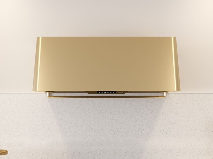 a gold television mounted to the side of a wall in a room with white walls