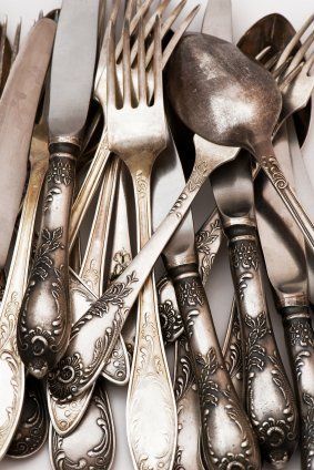 an assortment of antique silverware including spoons, forks and knives with ornate designs