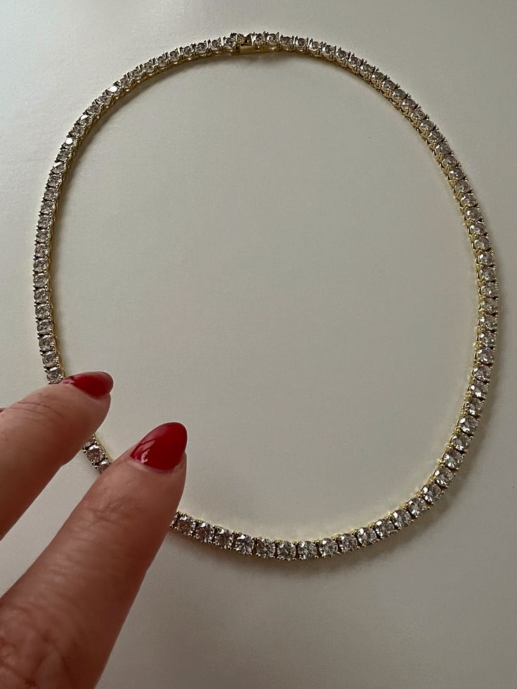 Classic CZ single strand tennis necklace Perfect for layering Available Lengths: 16" & 18" Stone size: 4MM Brass with silver and 14kt gold plating with CZ stones