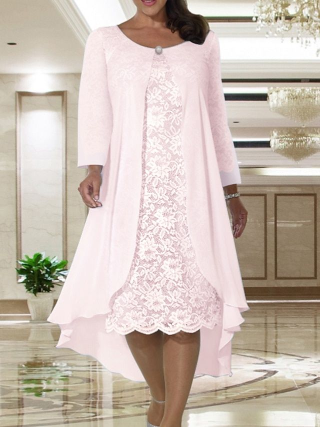 a woman wearing a pink dress and jacket