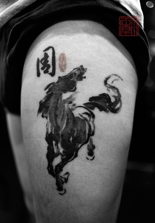 a man with a horse tattoo on his thigh