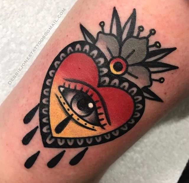 a heart tattoo with an eye on it