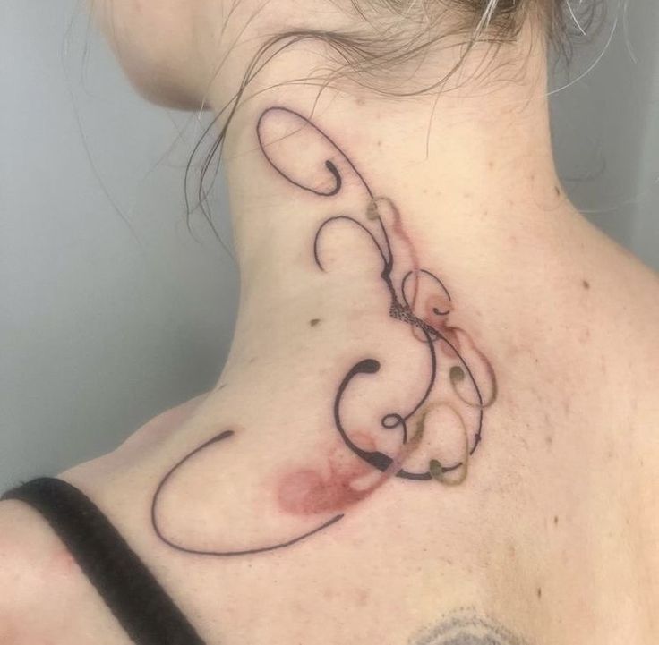 a woman with a tattoo on her neck