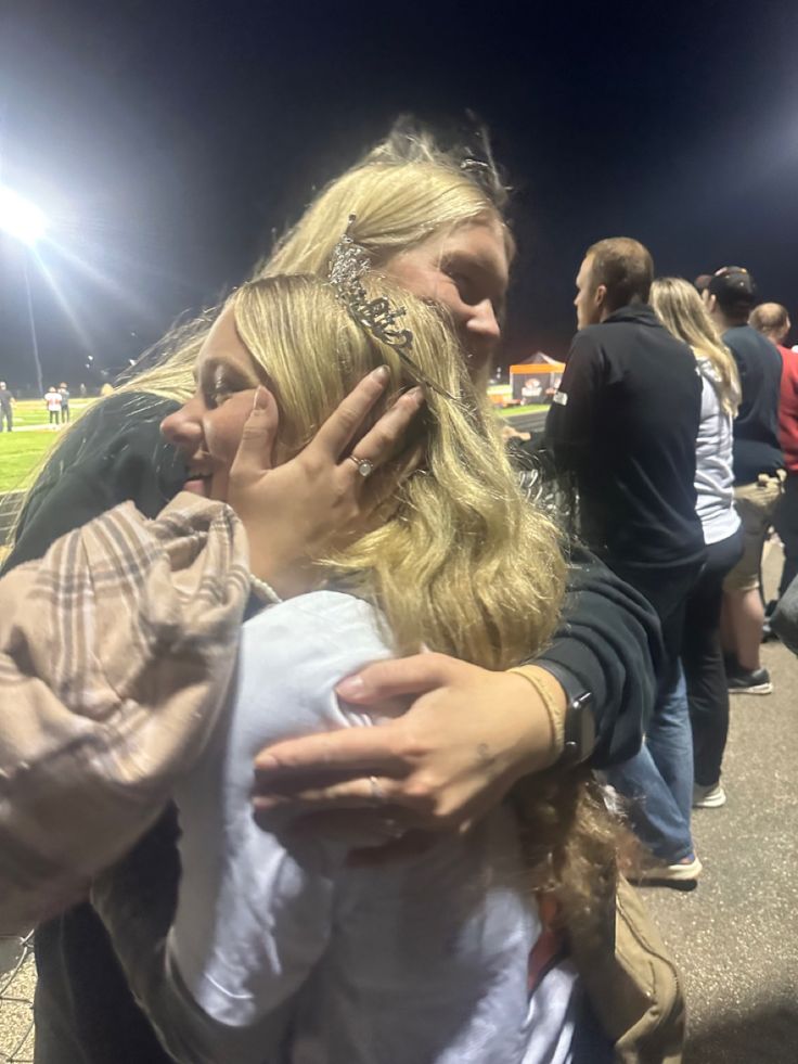 two women hug each other on the field