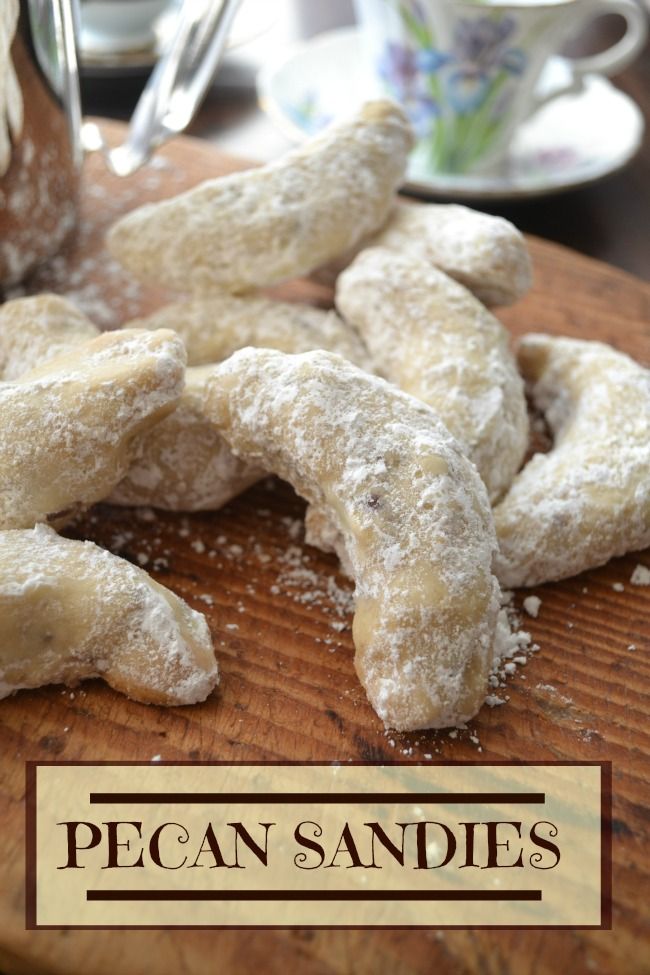 some powdered sugar cookies are on a cutting board