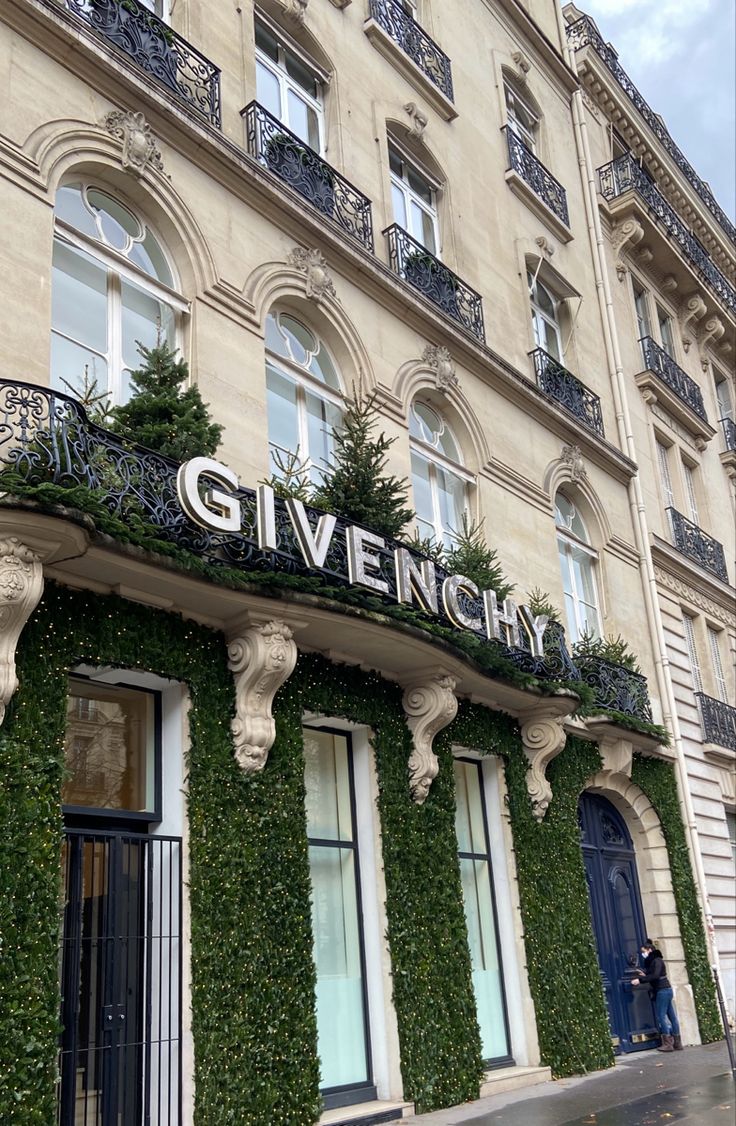 the front of a building covered in ivy