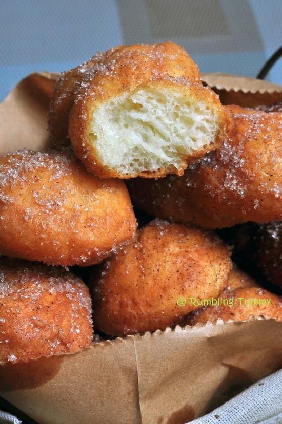 a basket filled with sugar covered donuts