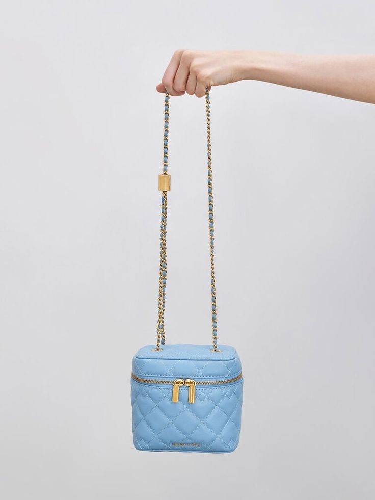 Commanding attention with its vibrant light blue hue, our Nezu bag is a heavyweight when it comes to both style and function. Elegant with classic quilting and featuring a hint of gold-toned hardware, it will make the perfect outfit companion for evening events or soirees. It also doubles up as a vanity case that will keep your cosmetics and toiletries safe and organised on your holiday trips and staycations. Boxy Bags, Size Chart For Kids, Vanity Case, How To Finish A Quilt, Charles Keith, Bag Light, Printables Kids, Holiday Travel, Blue Hues