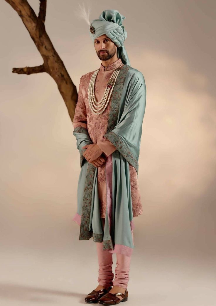 Featuring our work of art in orchid pink sherwani with intricate hand embroidery details using shades of pink and zari. Paired with a chateau grey hand-embroidered stole and safa. Pink Traditional Churidar For Transitional Season, Transitional Pink Churidar With Traditional Drape, Pink Traditional Naqshi Sherwani, Traditional Silk Bandhgala For Reception, Designer Pink Sherwani Straight Kurta, Silk Sherwani With Zari Work And Traditional Drape, Pink Sherwani With Resham Embroidery In Traditional Drape, Designer Pink Semi-stitched Sherwani, Pink Sherwani With Intricate Embroidery