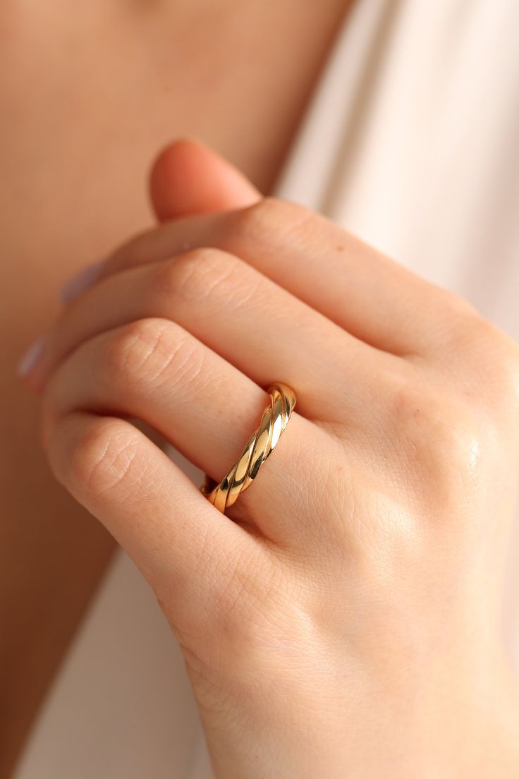 a woman's hand with a gold ring on it