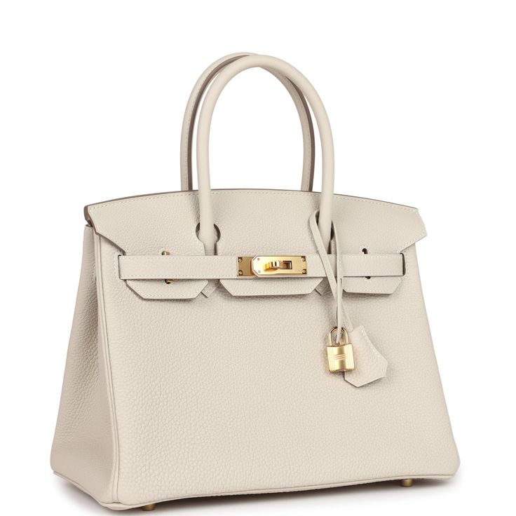 This Birkin is in Craie togo leather with gold hardware and has tonal stitching, front flap, two straps with center toggle closure, clochette with lock and two keys, and double rolled handles.The interior is lined with Craie chevre and has one zip pocket with an Hermes engraved zipper pull and an open pocket on the opposite side.Collection: WOrigin: FranceCondition: New and never worn (Plastic on hardware)Accompanied by: Hermes box, Hermes dustbag, clochette, lock, two keys, clochette dustbag, felt, carebook, ribbonMeasurements: 11.75" width x 9.5" height x 6" depth; 4.25" handle drop Luxury Everyday Bag In Togo Leather With Turn-lock Closure, Timeless Togo Leather Bag With Gold-tone Hardware, Classic Togo Leather Bag With Gold-tone Hardware, Timeless Togo Leather Bag With Lock, Timeless Bags With Metal Hardware And Togo Leather, Timeless Togo Leather Bag With Metal Hardware, Elegant Togo Leather Bag With Gold-tone Hardware, Elegant Togo Leather Bags With Metal Hardware, Timeless Cream Bag With Turn-lock Closure