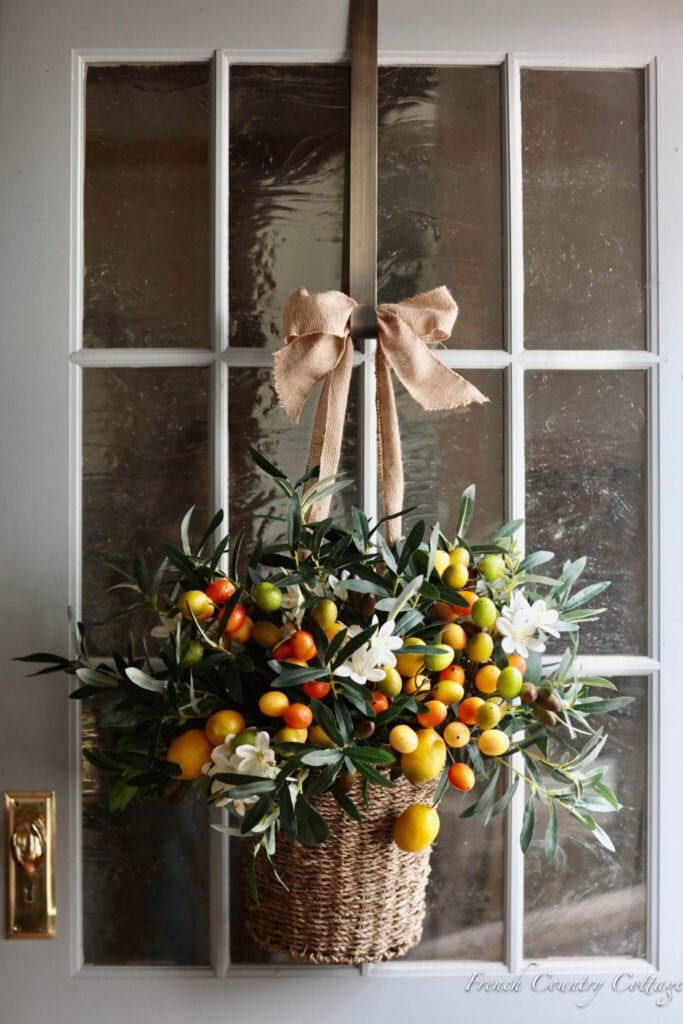 a basket filled with oranges sitting on top of a window sill next to a door