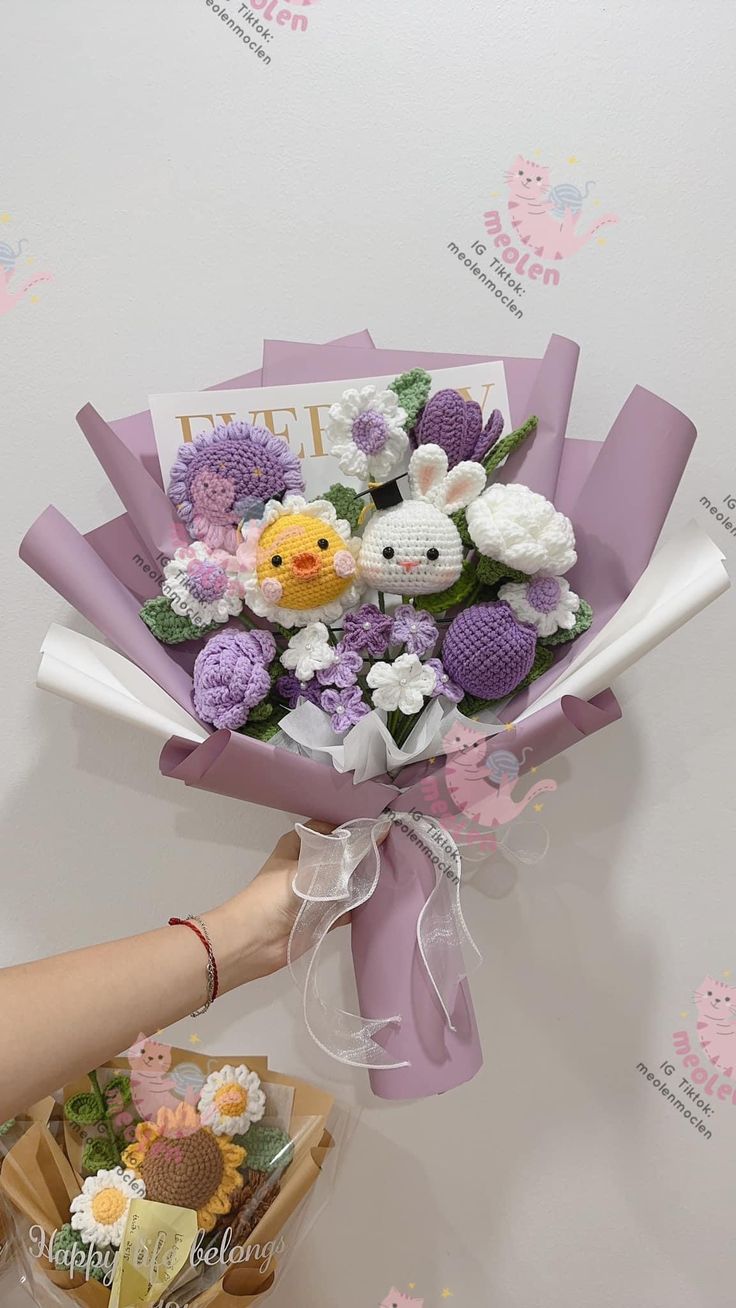 a person holding a bouquet of flowers in front of a wall