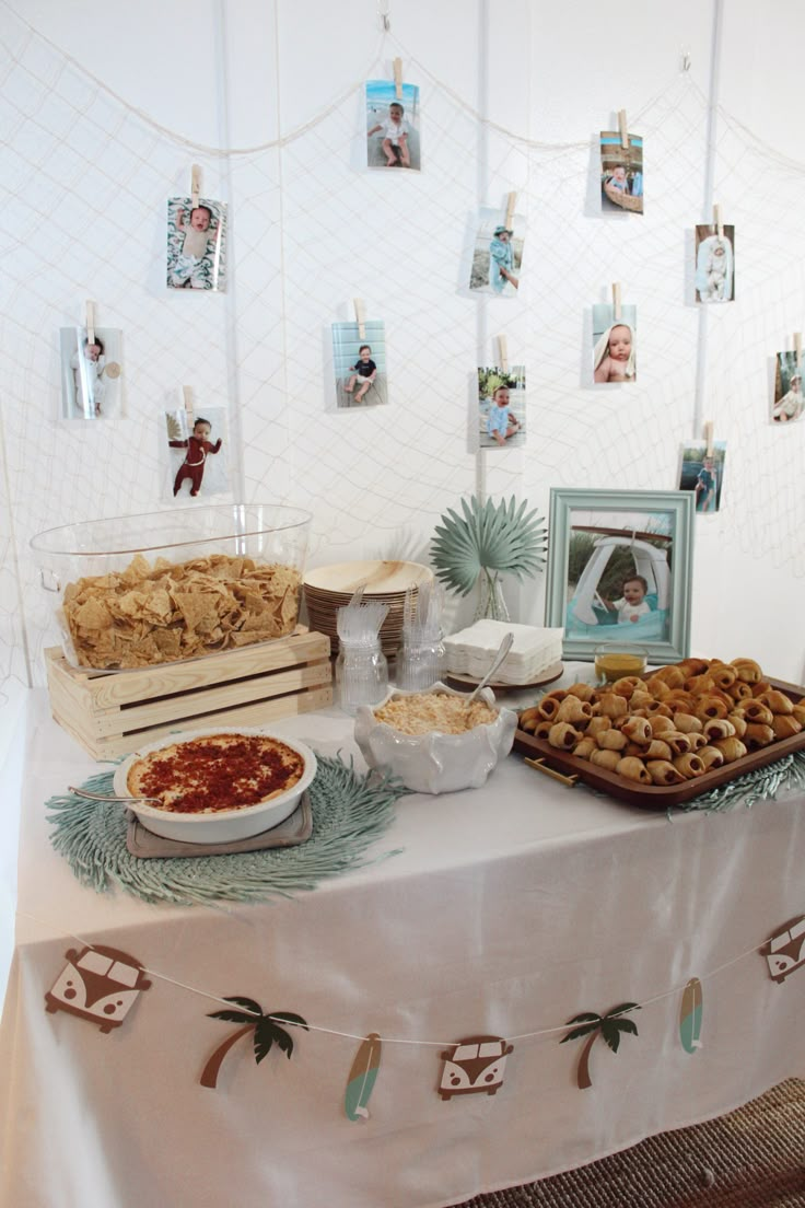 a table topped with lots of food next to pictures