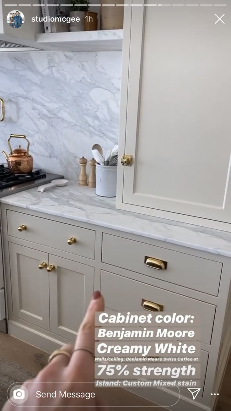 a kitchen with white cabinets and gold pulls on the cabinet doors is shown in this ad