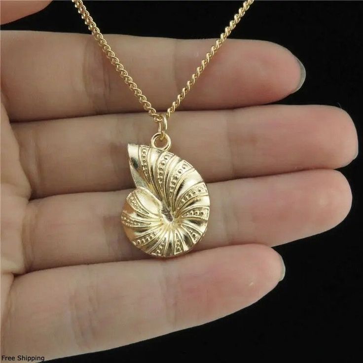 Dive into oceanic elegance with our Nautilus Shell Necklace. This exquisite piece features a meticulously crafted nautilus shell pendant, plated in luxurious 18k gold, capturing the timeless beauty of the sea. Perfect for beach lovers and boho enthusiasts, this necklace brings a touch of tropical charm to any outfit. The nautilus shell pendant showcases intricate details, making it a standout piece in your jewelry collection. The 18k gold plating adds a sophisticated touch, ensuring it complemen Ocean Style, Ocean Fashion, Sea Snail, Nautilus Shell, Ocean Jewelry, Gold Choker Necklace, Conch Shell, Gold Choker, Shell Pendant