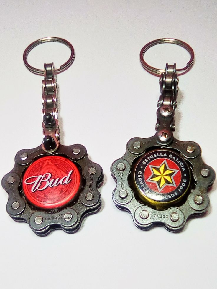 two metal bottle caps with the word bud on them are sitting next to each other