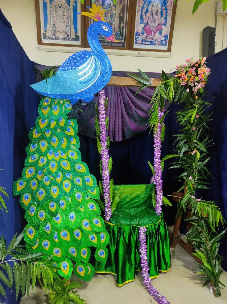 a peacock sitting on top of a green chair next to purple flowers and greenery